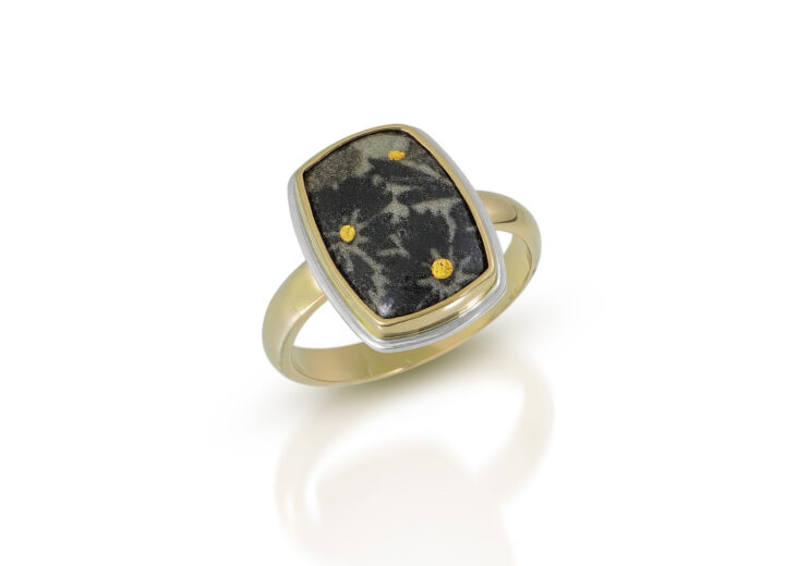 Green enamel rectangle with black flowers and gold dots in gold ring