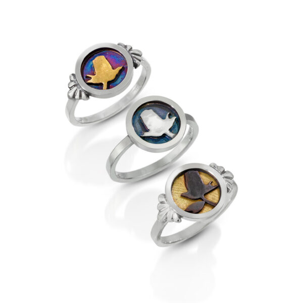 Three silver rings with a rose in circle and gold accents