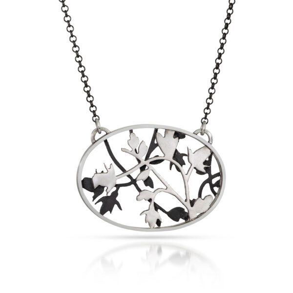 Black and silver oval necklace with layered rose and vine shapes