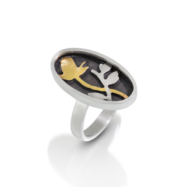 Oval ring with black, silver, and gold rose and vine