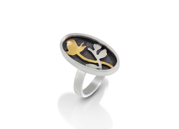 Oval ring with black, silver, and gold rose and vine